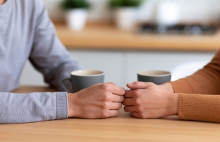 Romantic Couple Holding Hands at Modern Kitchen Table Sharing De